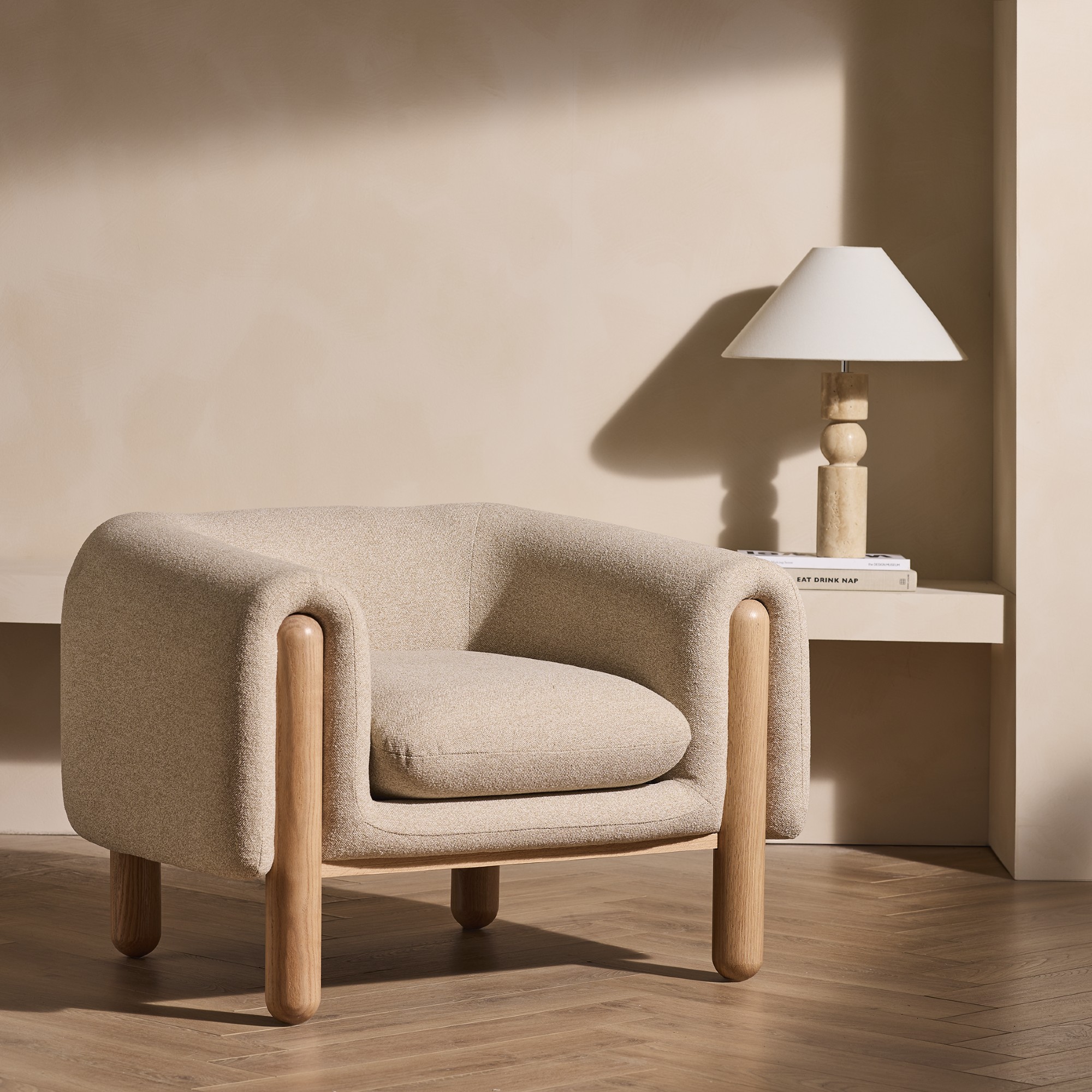 Habitat Drape fabric armchair in a room with off-white limewash walls and a totem-style table lamp on a built-in table