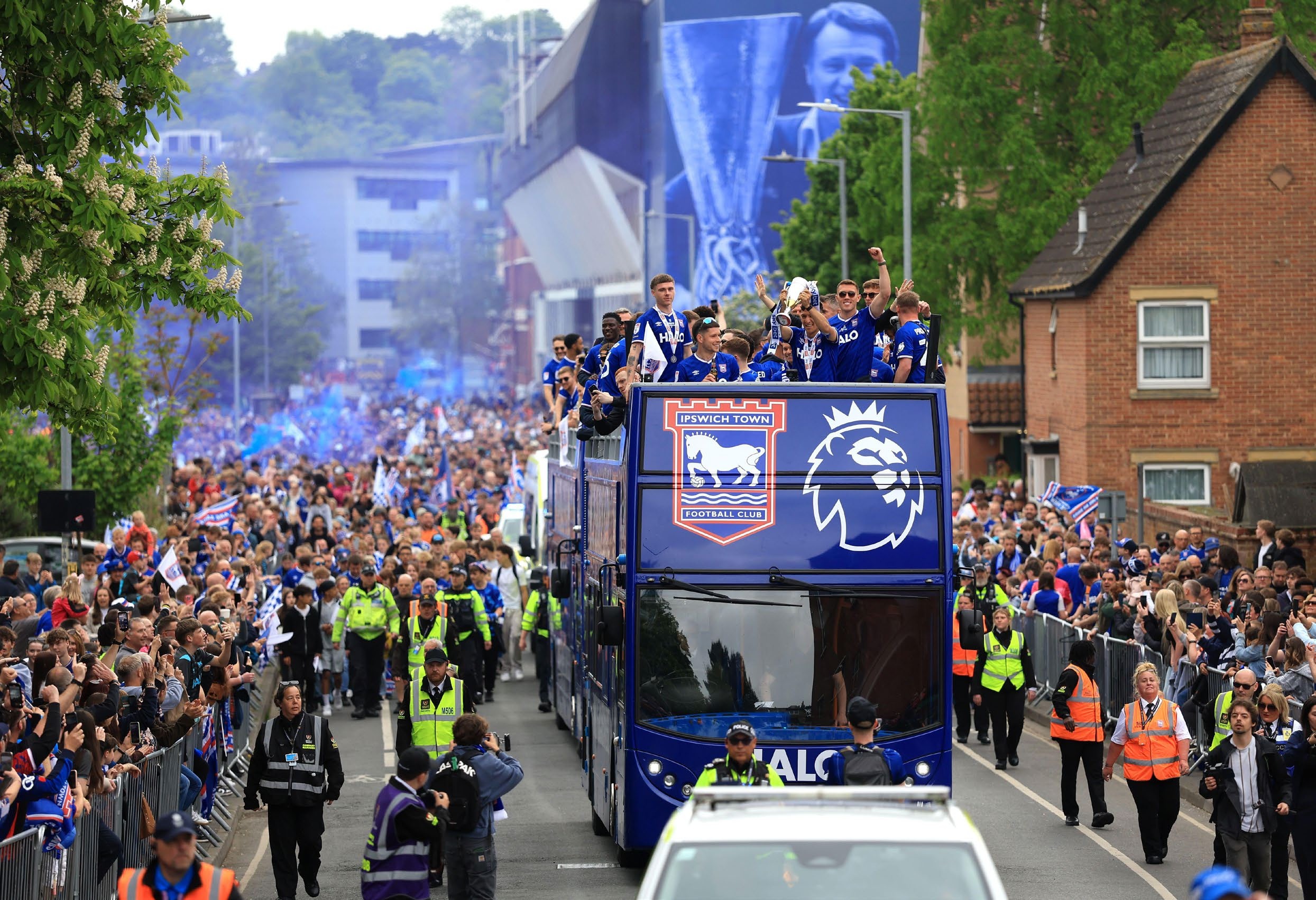 The Ipswich Town team bus approaches during a victory parade in Ipswich.