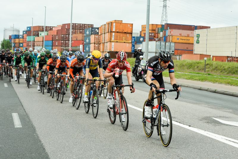 The peloton passes by another big shipping yard