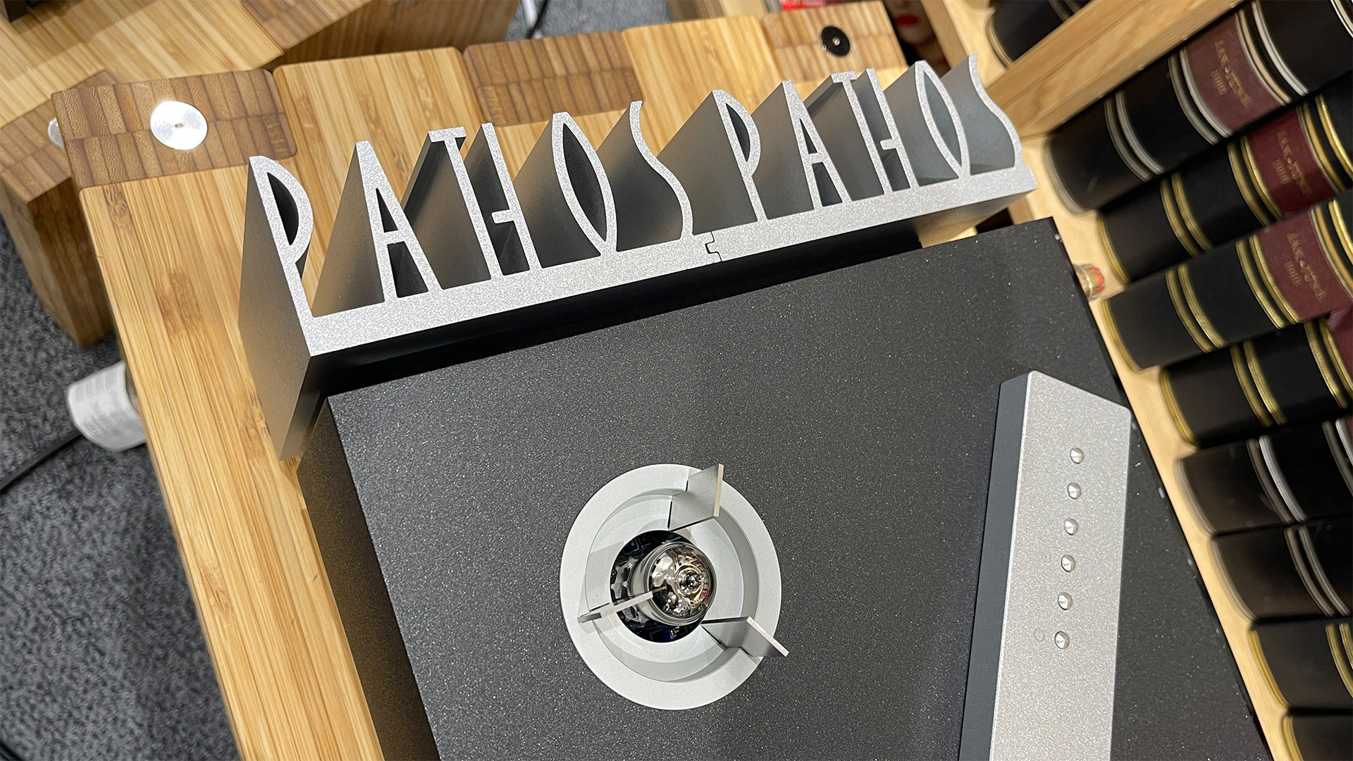 Pathos Inpol Remix MkII integrated amplifier on wooden hi-fi rack, top down view showing 'Pathos' heatsink