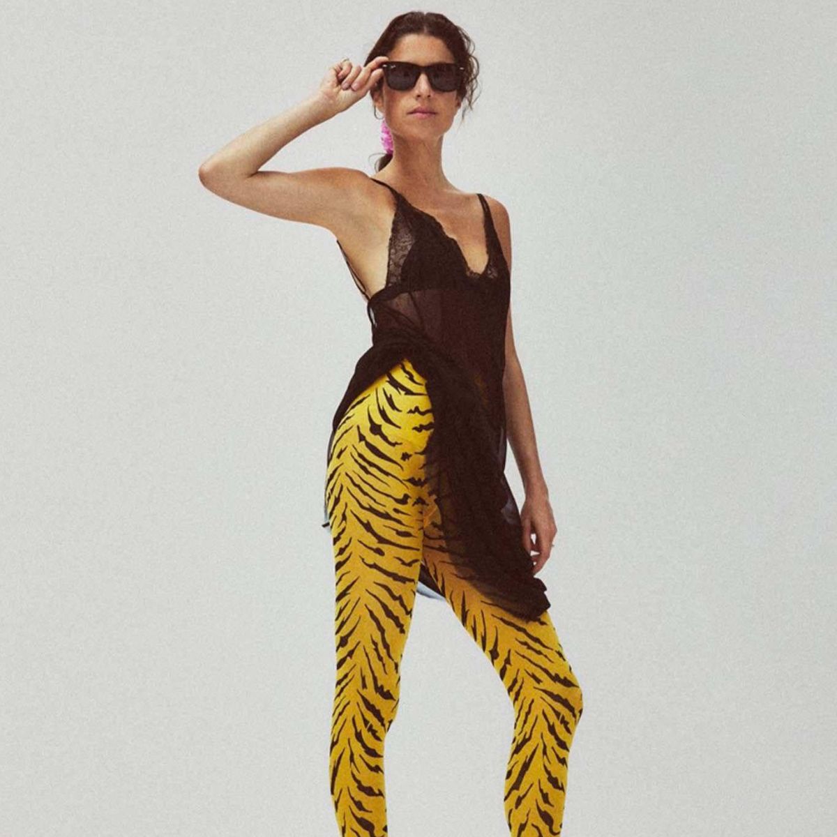 leandra medine wearing yellow tiger print statement tights by swedish stockings