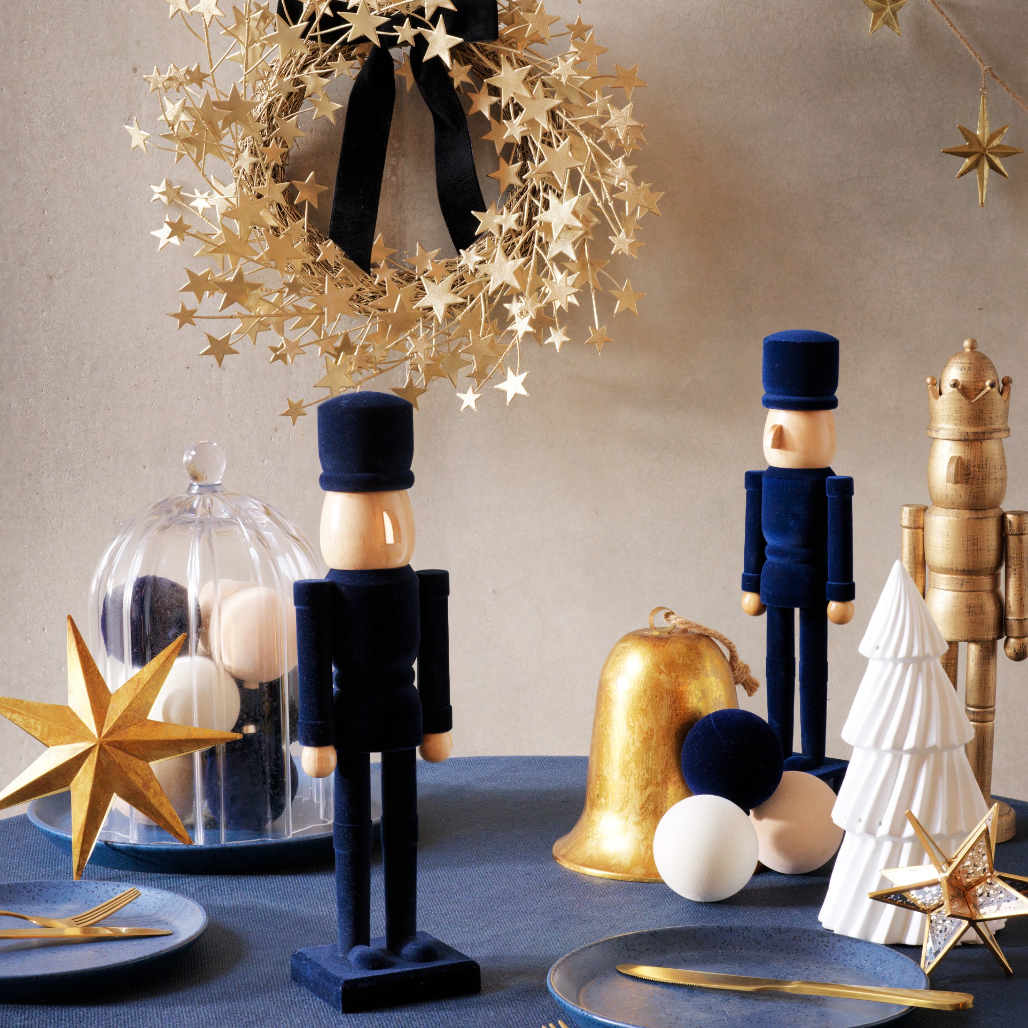A table decorated with navy velvet and gold Nutcracker figures from Habitat