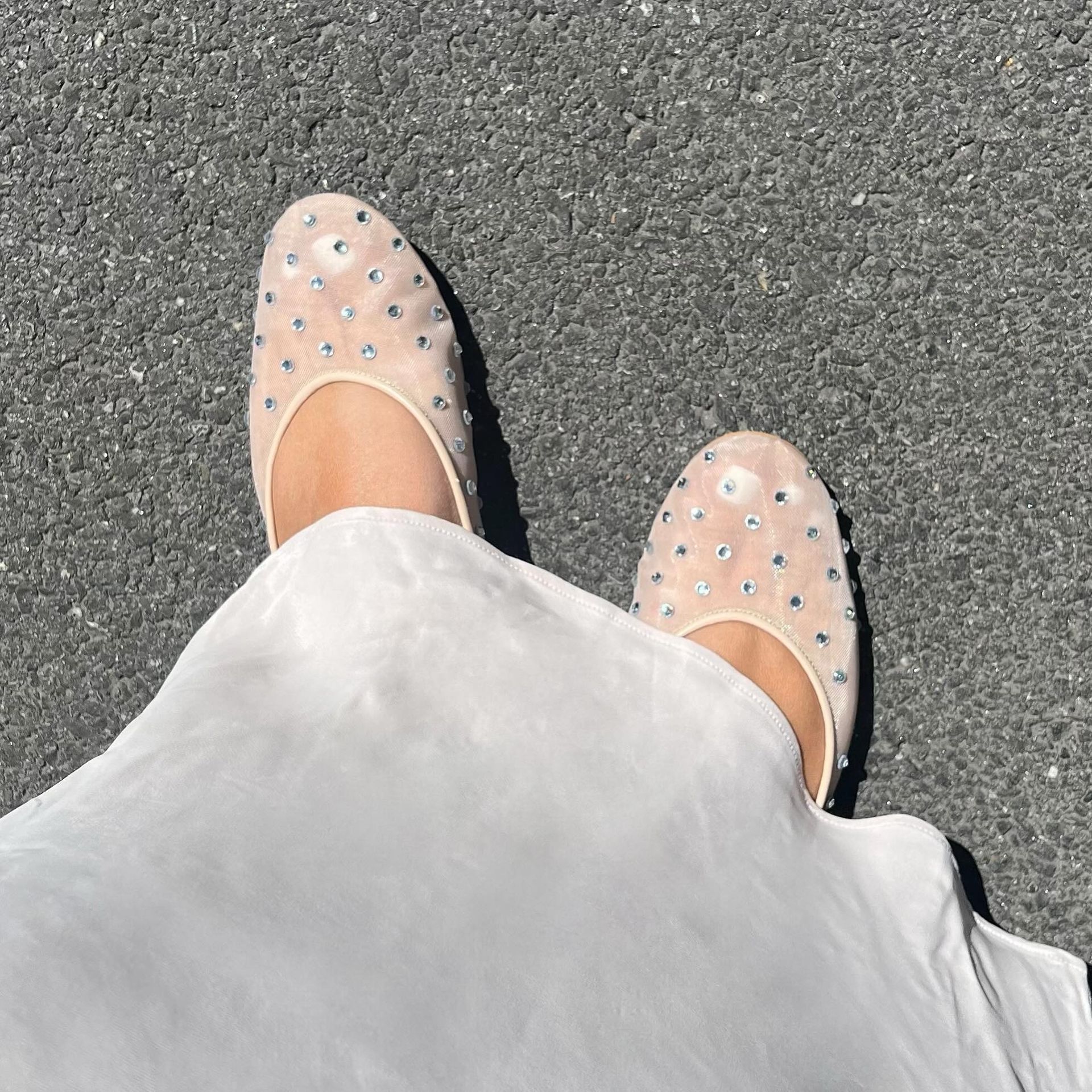 ana wears white skirt and mesh flats