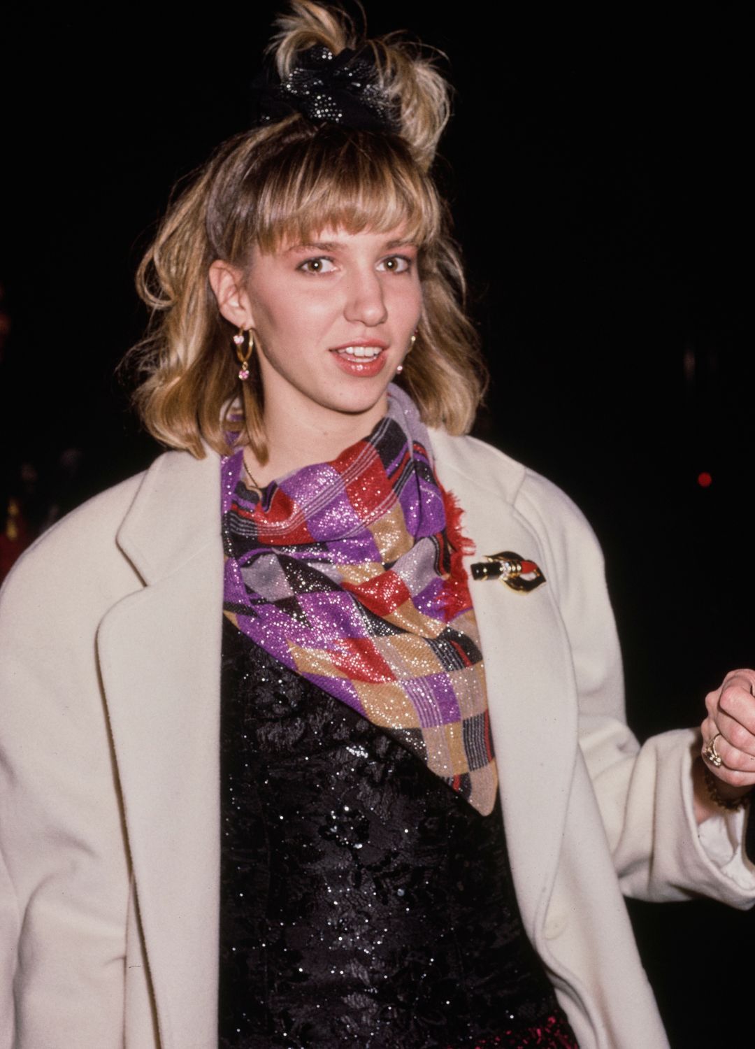 American singer and actress Debbie Gibson, wearing a white coat over a multicoloured outfit, attends the 30th Annual Grammy Awards at Radio City Music Hall in Midtown Manhattan, New York City, New York, 2nd March 1988