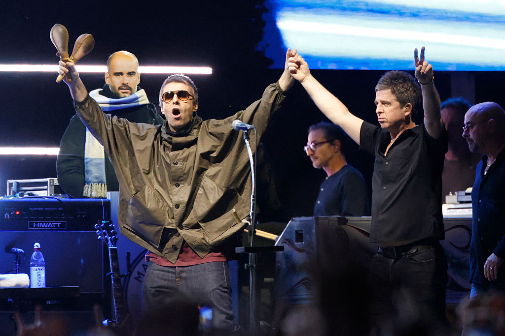 Oasis, including Liam Gallagher and Noel Gallagher, arrive on stage at Soldier Field in Chicago