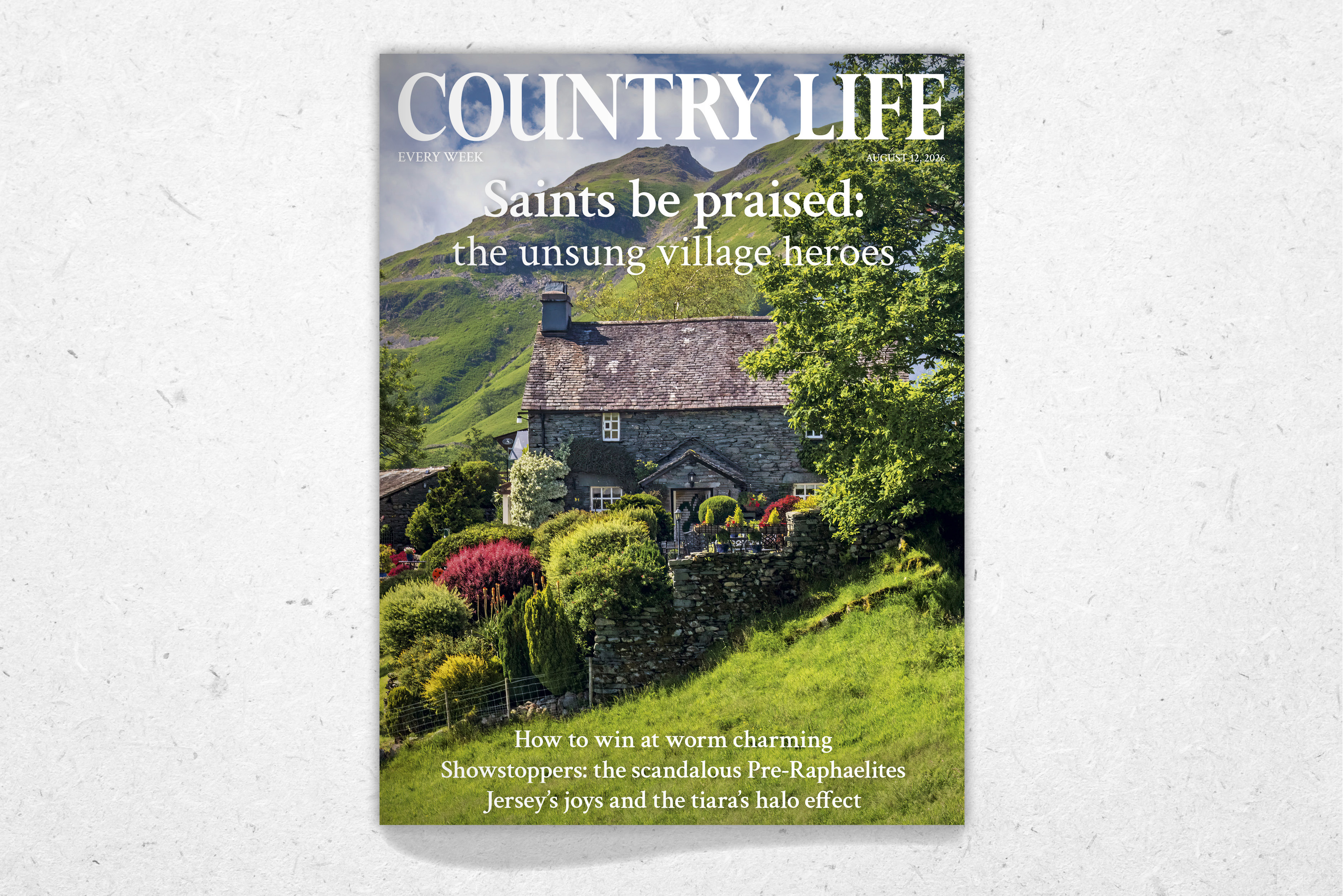A cover of Country Life, showing a cottage tucked into a hillside with a bursting colourful garden