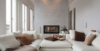 quiet luxury style living room with neutral color scheme with warm natural accent colored cushions