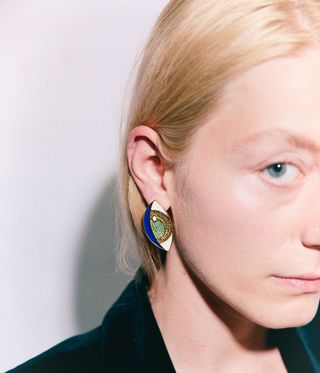 Woman wearing evil eye earring by colourful jewellery brand Boulo