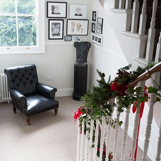 landing with staircase and white wall with armchair