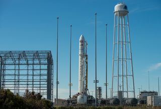 An Orbital ATK Antares rocket carrying the OA-5 Cygnus cargo ship is raised into launch position at Pad 0A at at NASA's Wallops Flight Facility in Virginia on Oct. 14, 2016.