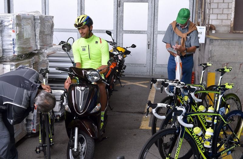 Daniele Bennati relaxes on a scooter at the team bus before the stage