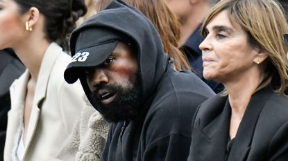 Ye West wearing a black cap and gum shield at Paris Fashion Week