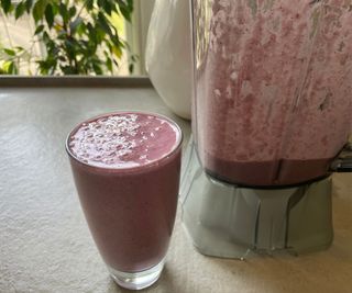 A glass of smoothie made in the Nama C2 Blender and Juicer