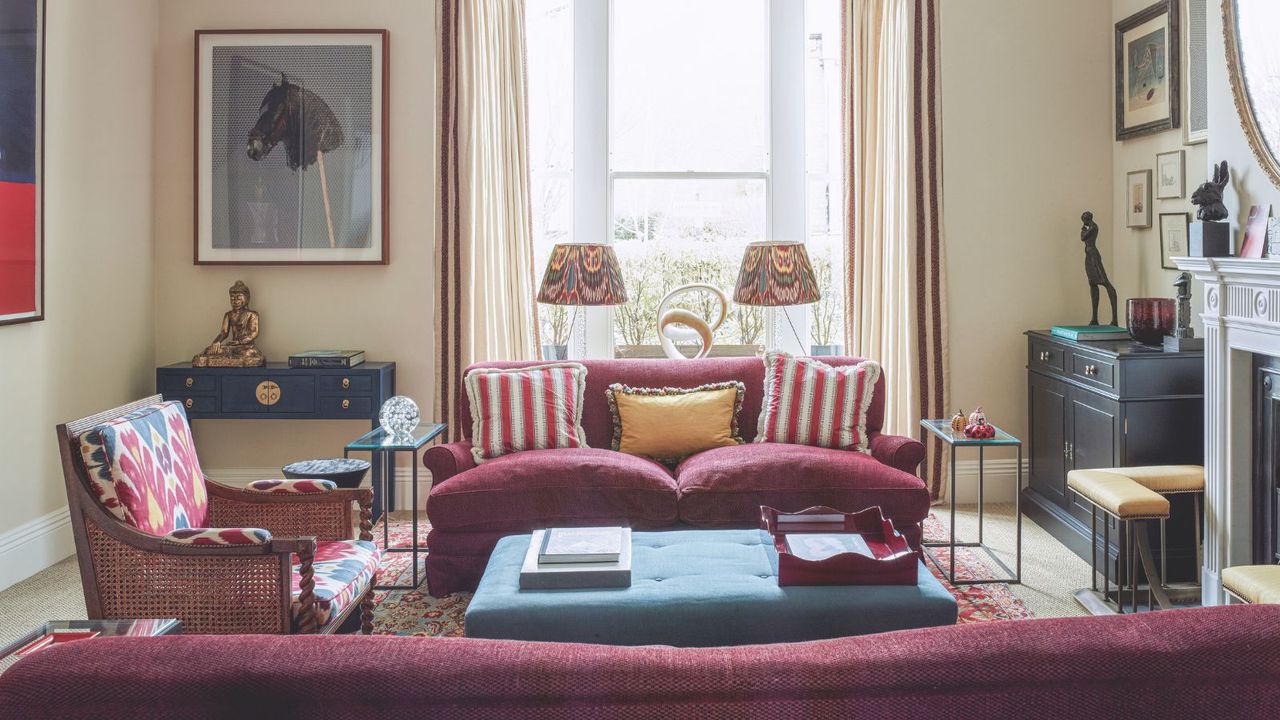 A Victorian living room with red sofas and floral decor for spring