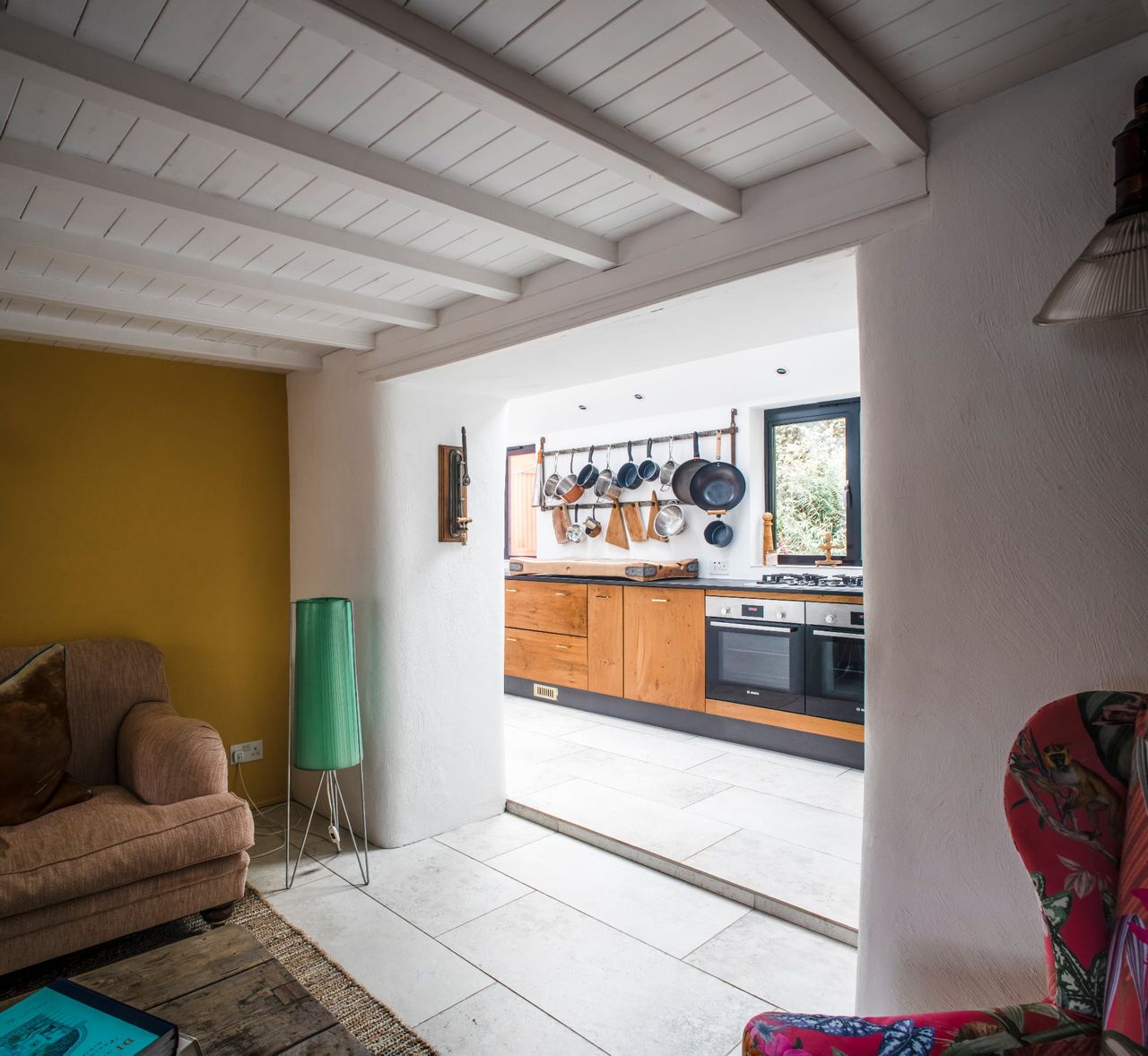 A cottage kitchen extension with wooden beams and reclaimed fittings