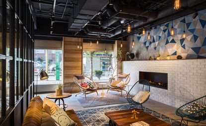 Moxy — Tokyo, Japan - sitting room with fireplace