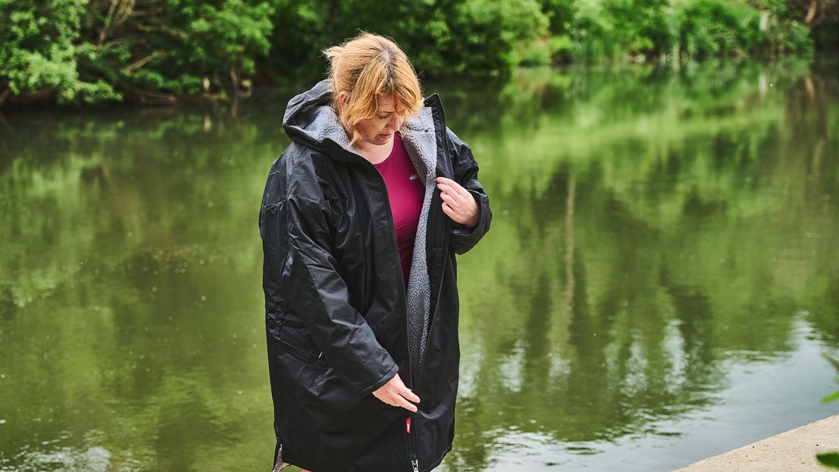 Alpkit Haven changing robe being worn by a river