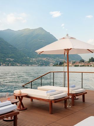 loungers and parasol at Mandarin Oriental floating infinity pool platform by Herzog and de Meuron