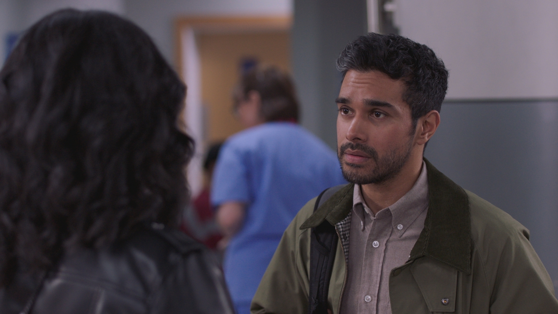 Rash talks to Sunny with a worried look on his face as they prepare to leave the hospital at the end of their shift.