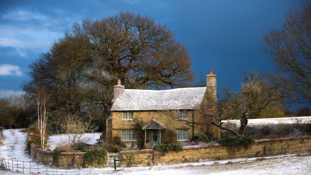 rosehill cottage, the holiday&#039;s house, in 2006 movie sprinkled in snow with a blue sky background