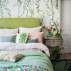 Green bed with botanical wallpaper