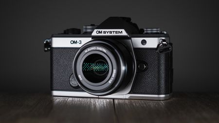 OM System OM-3 on a wooden surface