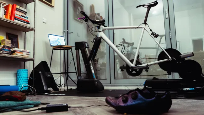 A bike mounted to a smart trainer indoors