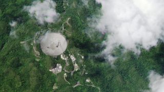 A satellite image taken by one of Planet's SkySat satellites shows the damaged radio dish at the Arecibo Observatory in Puerto Rico. The image was captured at 10:50 a.m. EDT (1450 GMT) on Aug. 10, 2020, about eight hours after a support cable broke and smashed into the dish.