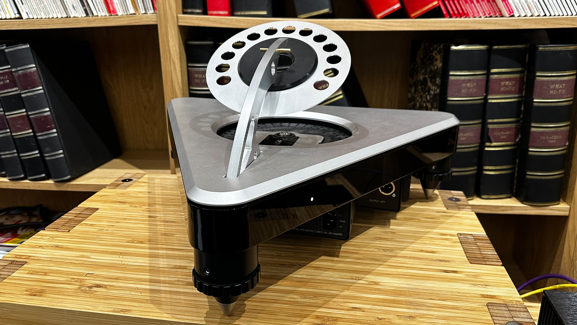 Gryphon Audio Ethos CD player on wooden hi-fi rack in front of bookcase, lid is open