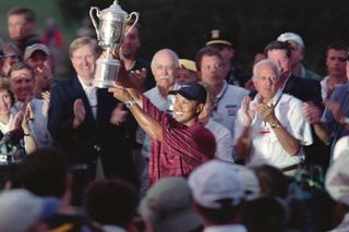 Tiger Woods kisses the US Open trophy in 2002