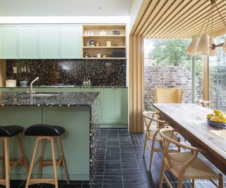 open plan kitchen and dining space with wood cladding