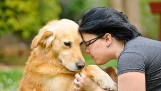 Woman and dog looking sad