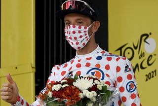 Team Israel Start Up Nations Michael Woods of Canada celebrates best climbers polka dot jersey on the podium at the end of the 14th stage of the 108th edition of the Tour de France cycling race 183 km between Carcassonne and Quillan on July 10 2021 Photo by Philippe LOPEZ AFP Photo by PHILIPPE LOPEZAFP via Getty Images