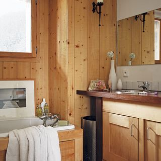 bathroom with wooden wall and washbisn and bathtub