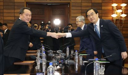 Korean unification ministers shake hands