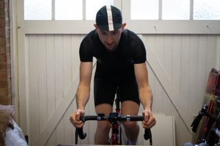 a cyclist riding on an indoor trainer