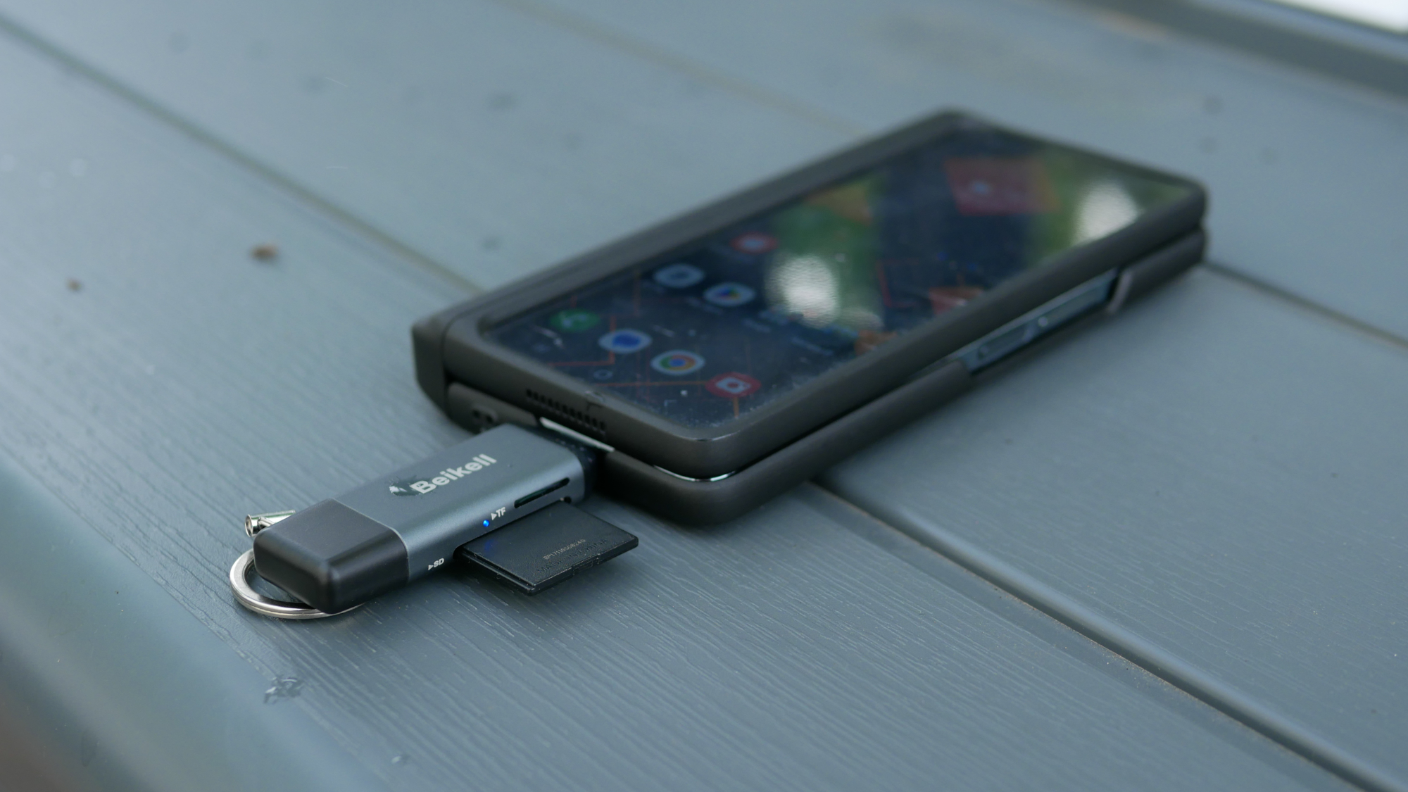 Beikell USB memory card reader adapter connected to smartphone.