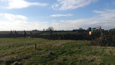 Quorn hunt next to a digger at Lauren Shannon's new yard