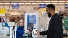 Woman scanning Tesco clubcard