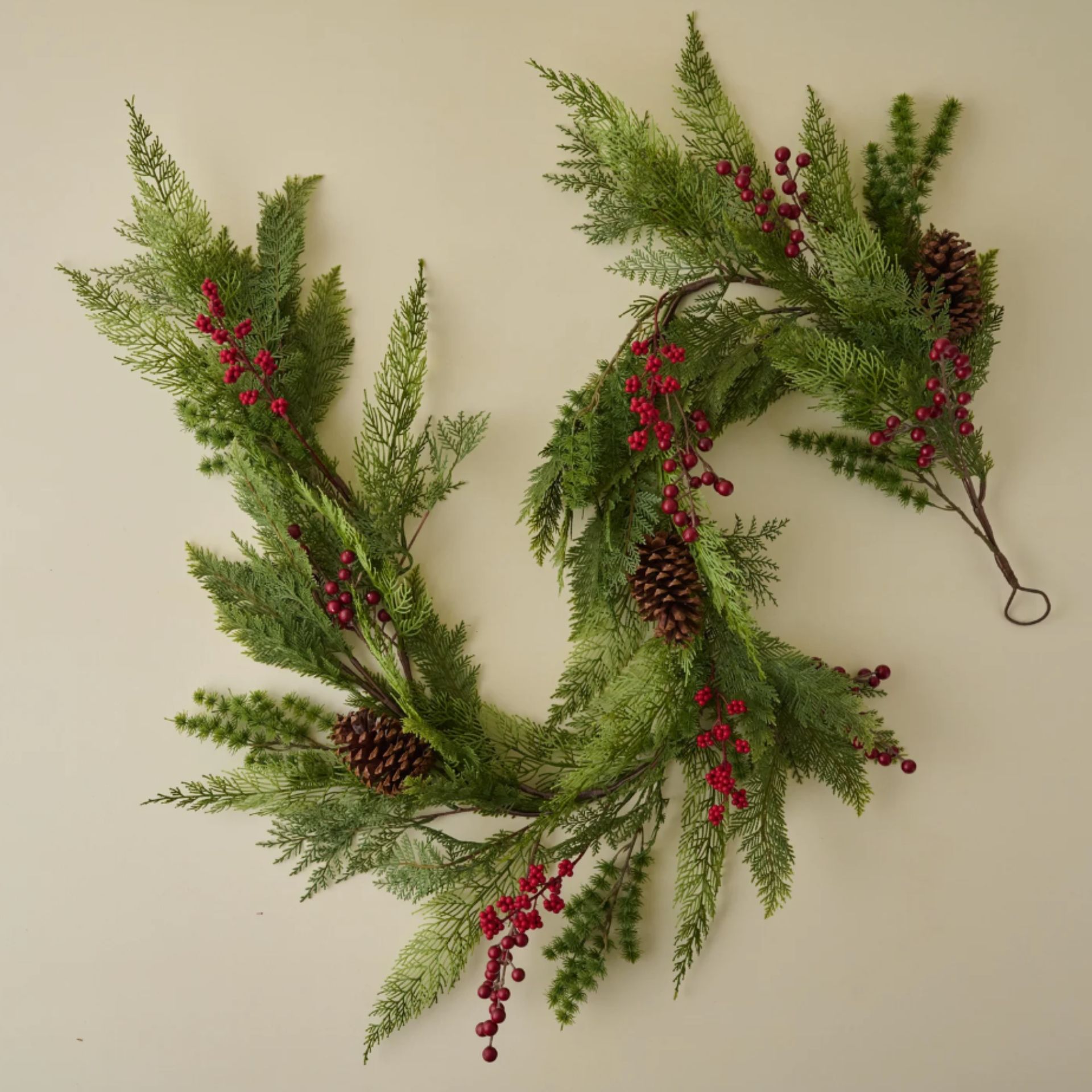 Faux pine garland with red berries and pinecones