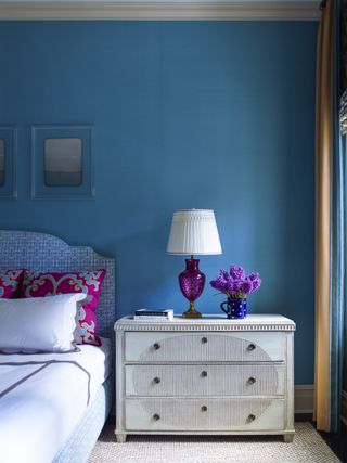 Blue wall and picture frames, blue and white pattern head board