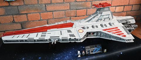 Side-on view of the Lego UCS Venator against a brick background