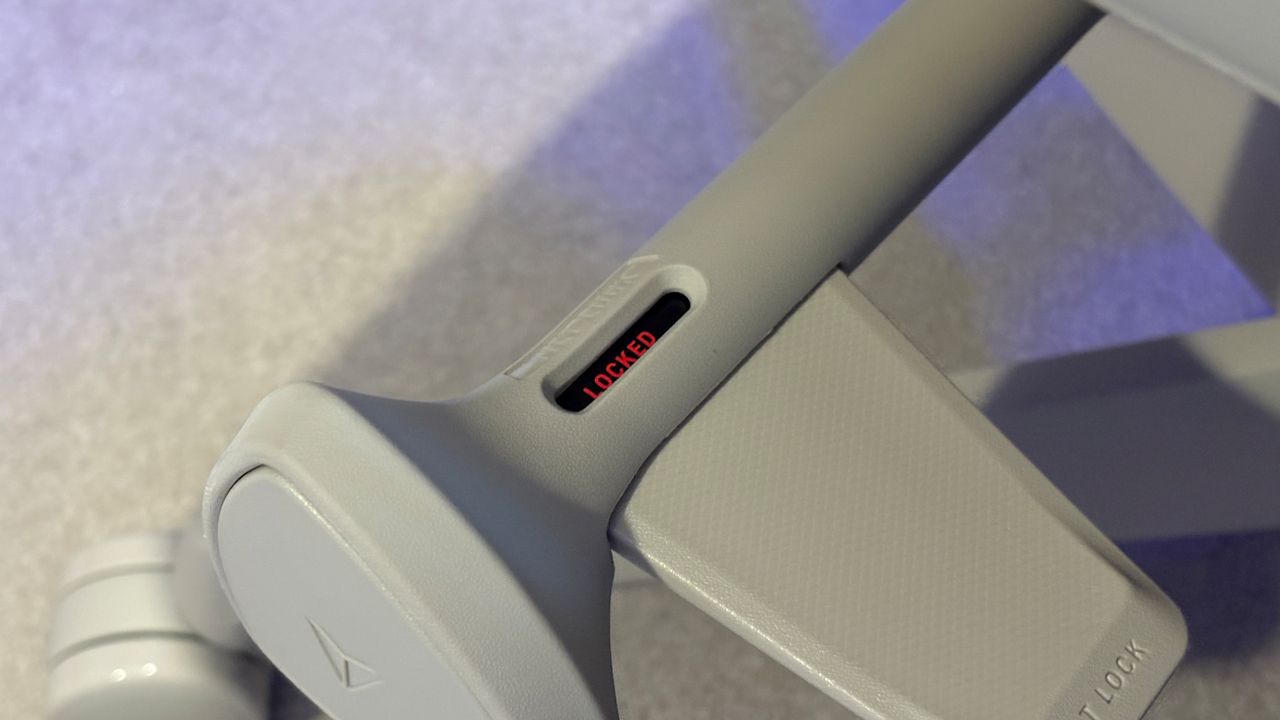 A Secretlab Atlas gaming chair in a home office during set-up and after it's completed.