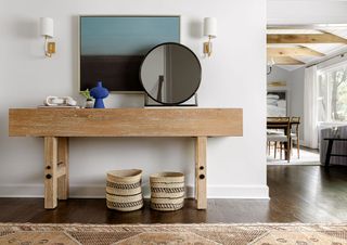 A white entryway with a chunky wooden console table