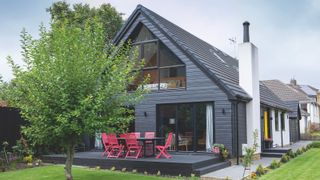 black cladding on remodelled bungalow with decking area