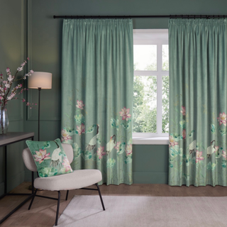 Green floral curtains and pillow with embellishments of birds