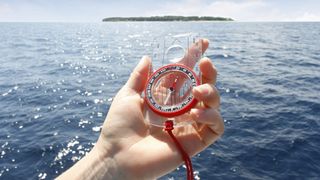 compass bubbles: compass held up in front of sea
