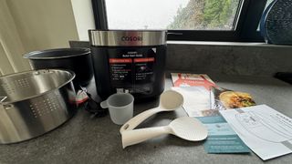 cosori 5.0-quart rice cooker box contents on grey worktops