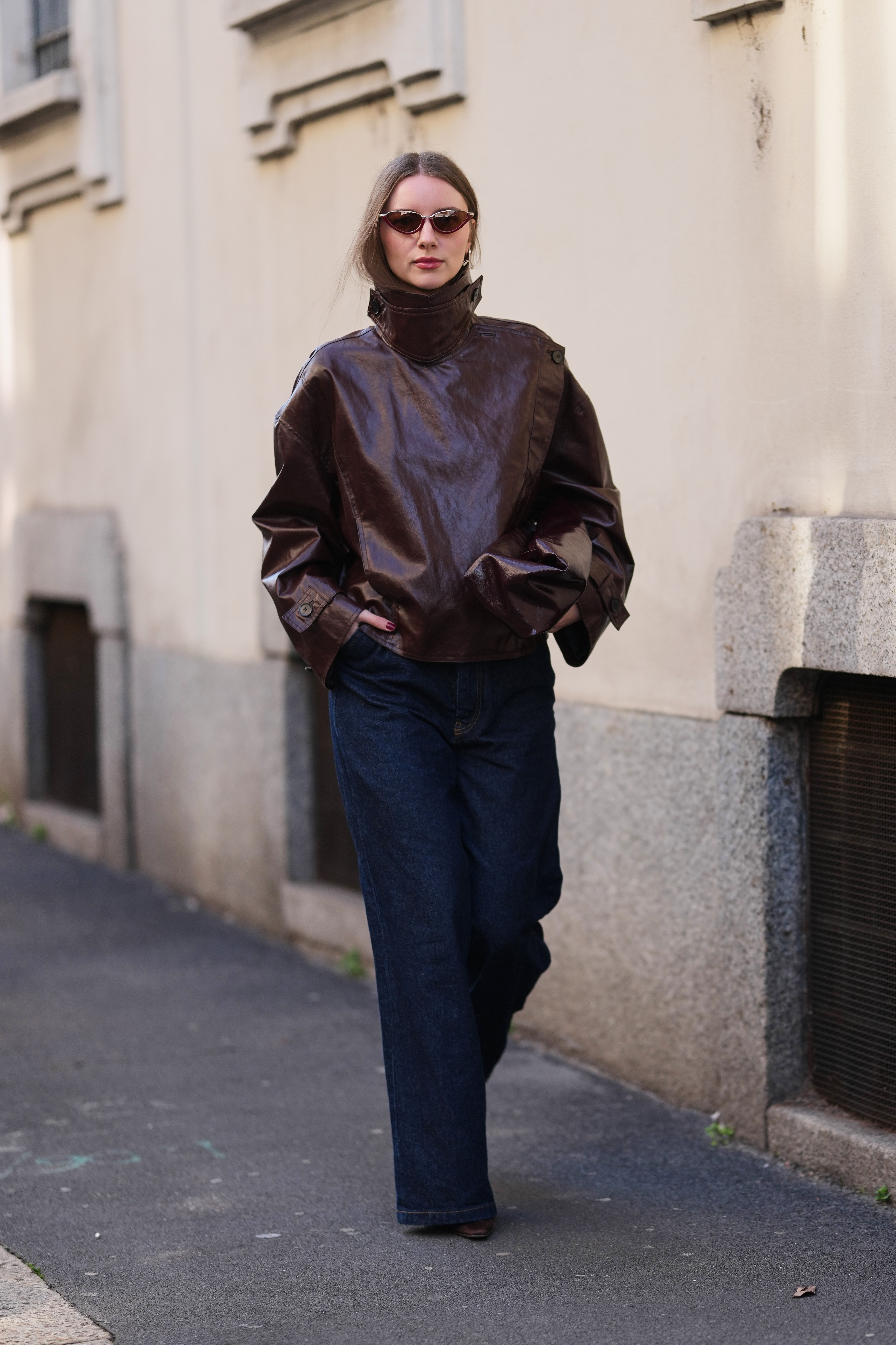 a woman wearing a jacket and jeans