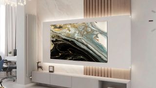 Sansui OLED TV mounted on a wall of a modern living room with a white media centre underneath